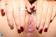 A woman with a ring on her finger is showing off her pussy.