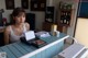 A woman sitting at a counter in a restaurant.