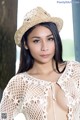 A woman wearing a straw hat posing for a picture.