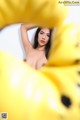 A woman is posing in a yellow flower.