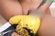 A close up of a person wearing a pair of yellow boxing gloves.