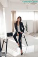 a woman sitting on top of a white table