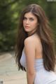 A woman with long brown hair is posing for a picture.