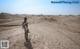 A person standing in the middle of a desert.